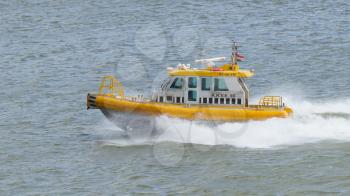 ROTTERDAM, THE NETHERLANDS - JUNE 22: Yellow Crewtender at high speed in the harbor of Rotterdam (Holland), Rotterdam, June 22, 2012