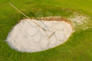Golf: sand trap on the green grass