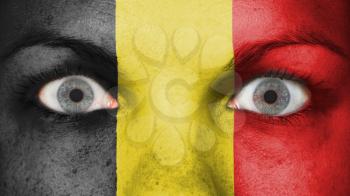 Close up of eyes. Painted face with flag of Belgium