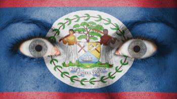 Close up of eyes. Painted face with flag of Belize