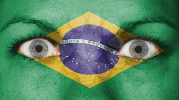 Close up of eyes. Painted face with flag of Brazil