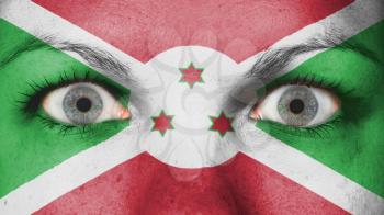 Close up of eyes. Painted face with flag of Burundi