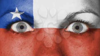 Close up of eyes. Painted face with flag of Chile