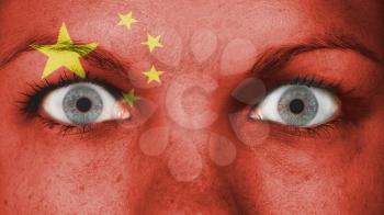 Close up of eyes. Painted face with flag of China