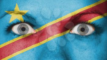 Close up of eyes. Painted face with flag of Congo