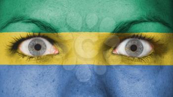 Close up of eyes. Painted face with flag of Gabon