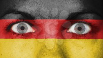 Close up of eyes. Painted face with flag of Germany