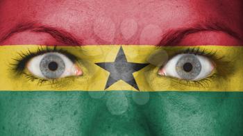 Close up of eyes. Painted face with flag of Ghana