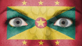 Close up of eyes. Painted face with flag of Grenada