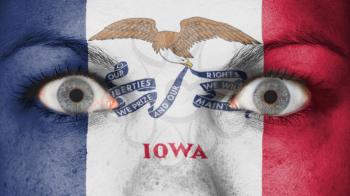 Close up of eyes. Painted face with flag of Iowa