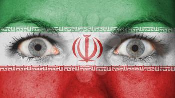 Close up of eyes. Painted face with flag of Iran
