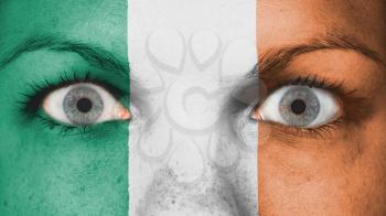 Close up of eyes. Painted face with flag of Ireland