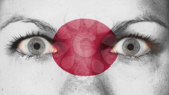 Close up of eyes. Painted face with flag of Japan