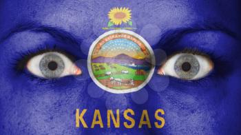 Close up of eyes. Painted face with flag of Kansas