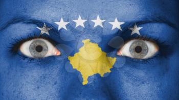Close up of eyes. Painted face with flag of Kosovo