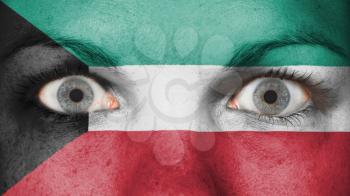 Close up of eyes. Painted face with flag of Kuwait
