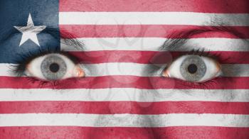 Close up of eyes. Painted face with flag of Liberia