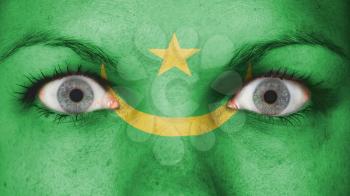 Close up of eyes. Painted face with flag of Mauritania