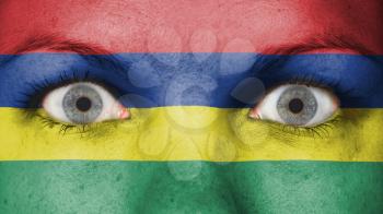 Close up of eyes. Painted face with flag of Mauritius