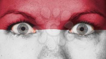 Close up of eyes. Painted face with flag of Monaco