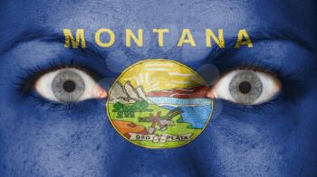 Close up of eyes. Painted face with flag of Montana