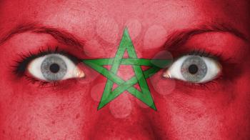Close up of eyes. Painted face with flag of Morocco