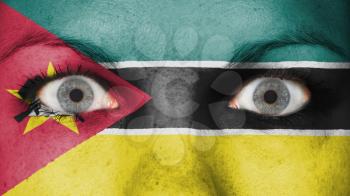 Close up of eyes. Painted face with flag of Mozambique