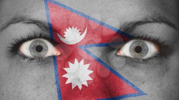 Close up of eyes. Painted face with flag of Nepal