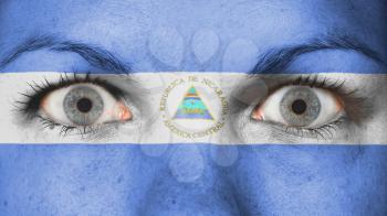 Close up of eyes. Painted face with flag of Nicaragua