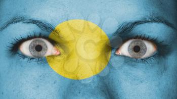 Close up of eyes. Painted face with flag of Palau