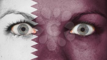 Close up of eyes. Painted face with flag of Qatar