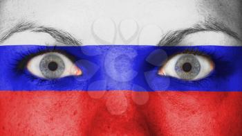 Close up of eyes. Painted face with flag of Russia