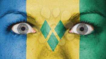 Close up of eyes. Painted face with flag of Saint Vincent and the Grenadines