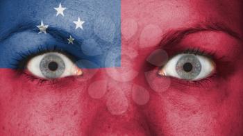 Close up of eyes. Painted face with flag of Samoa