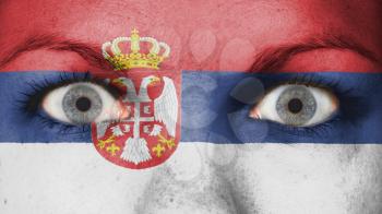 Close up of eyes. Painted face with flag of Serbia