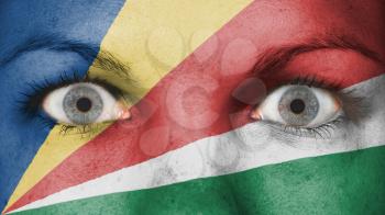 Close up of eyes. Painted face with flag of the Seychelles