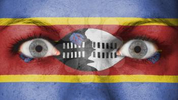 Close up of eyes. Painted face with flag of Swaziland