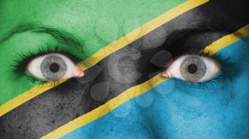 Close up of eyes. Painted face with flag of Tanzania