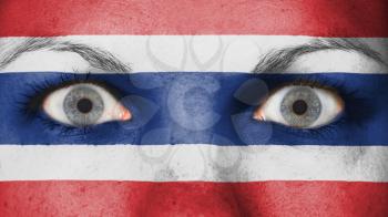 Close up of eyes. Painted face with flag of Thailand