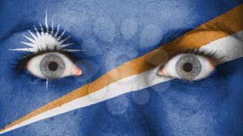 Close up of eyes. Painted face with flag of The Marshall Islands