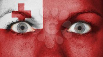 Close up of eyes. Painted face with flag of Tonga