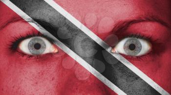 Close up of eyes. Painted face with flag of Trinidad and Tobago