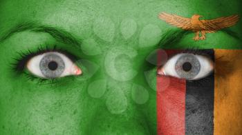 Close up of eyes. Painted face with flag of Zambia