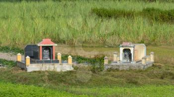 Two old graves in a field in central Vietnam