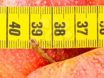 Apple diet, red apples with a yellow tape-measure