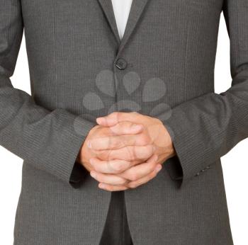 Business man in grey suit praying, isolated