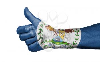Old woman giving the thumbs up sign, isolated, flag of Belize