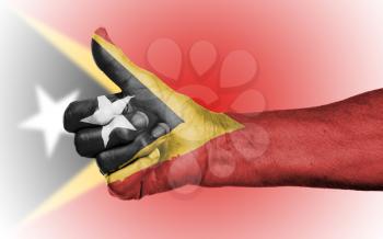 Old woman giving the thumbs up sign, isolated, flag of East Timor