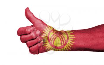 Old woman giving the thumbs up sign, isolated, flag of Kyrgyzstan