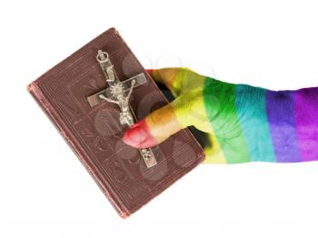 Old hand (woman) holding a very old bible, isolated on white, rainbow flag